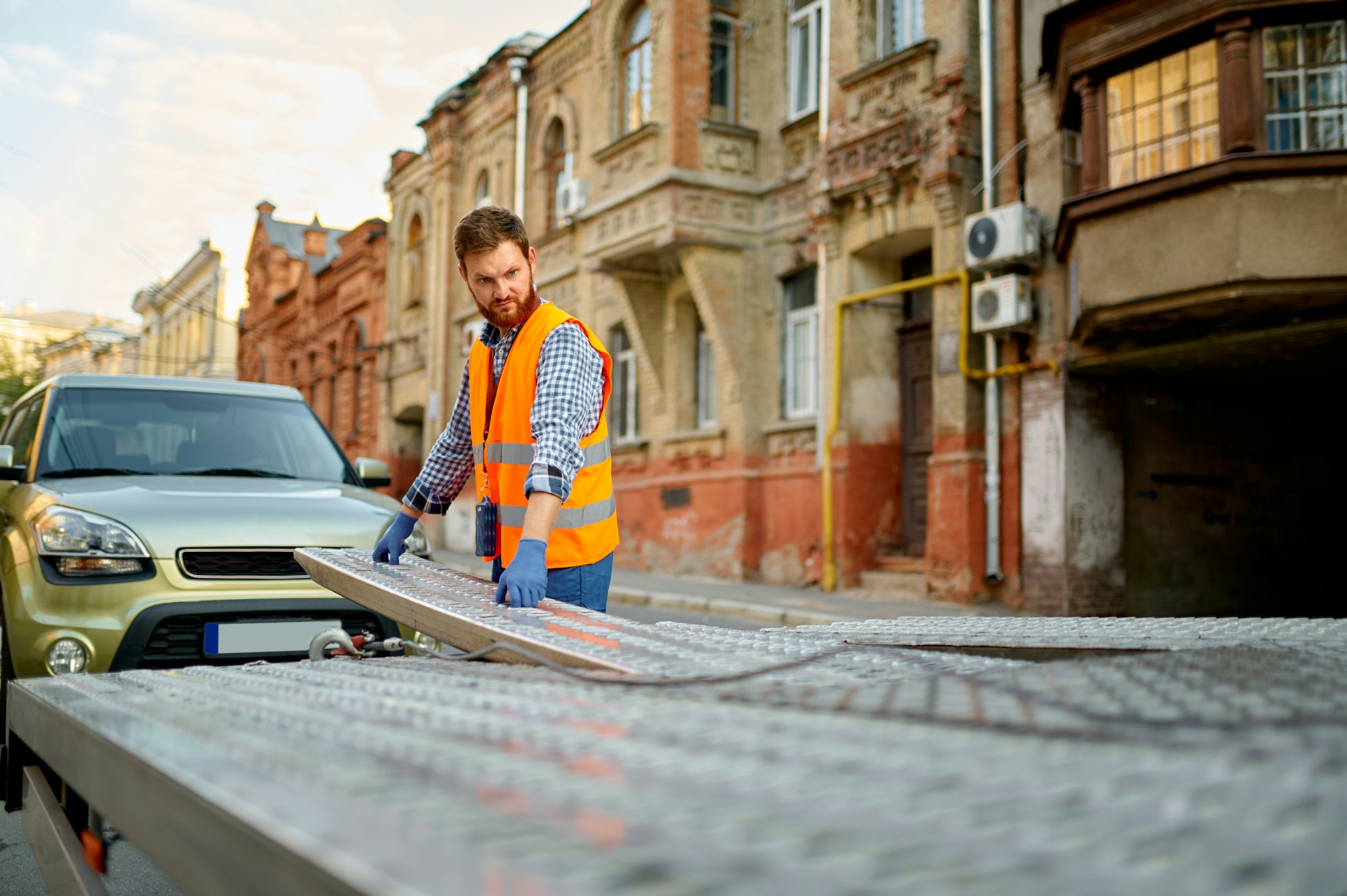 Man preparing towing truck for car loading